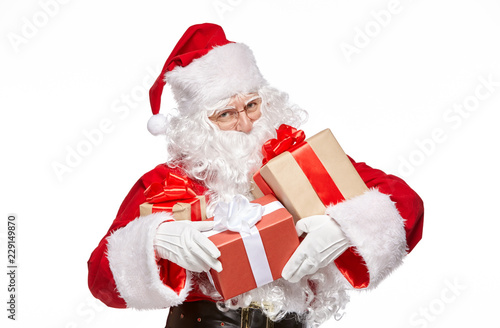 Happy Santa Claus is holding presents.