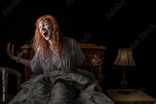 Obraz na plátně Scary woman possessed by devil in the bed