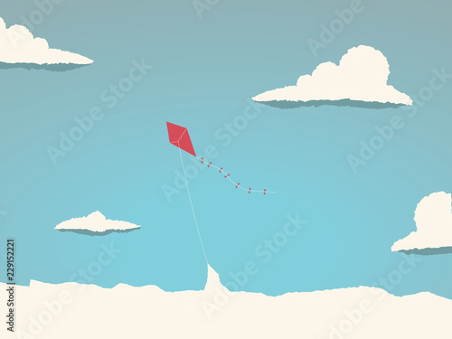Kite flying high in the sky above the clouds. Symbol of freedom, childhood, playful times.