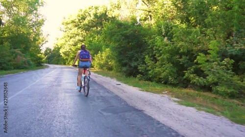 Wallpaper Mural Young couple biking on a forest road in a sammer day. active recreation, sport, healthy lifestyle Torontodigital.ca