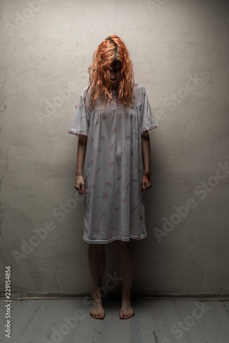 Scary ghost woman in nightgown with knife / halloween, zombie concept © filipobr