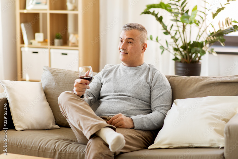 people, alcohol and drinks concept - man drinking red wine from glass at home people, alcohol and drinks concept - man drinking red wine from glass at home