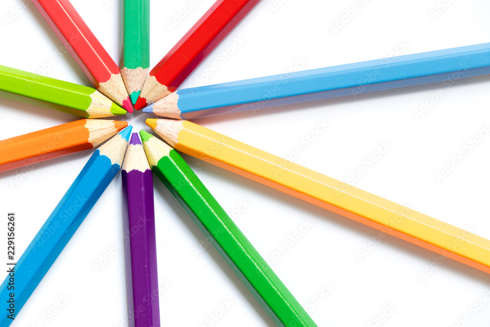 Color pencil arrange in ray shape on white paper background Color pencil arrange in ray shape on white paper background