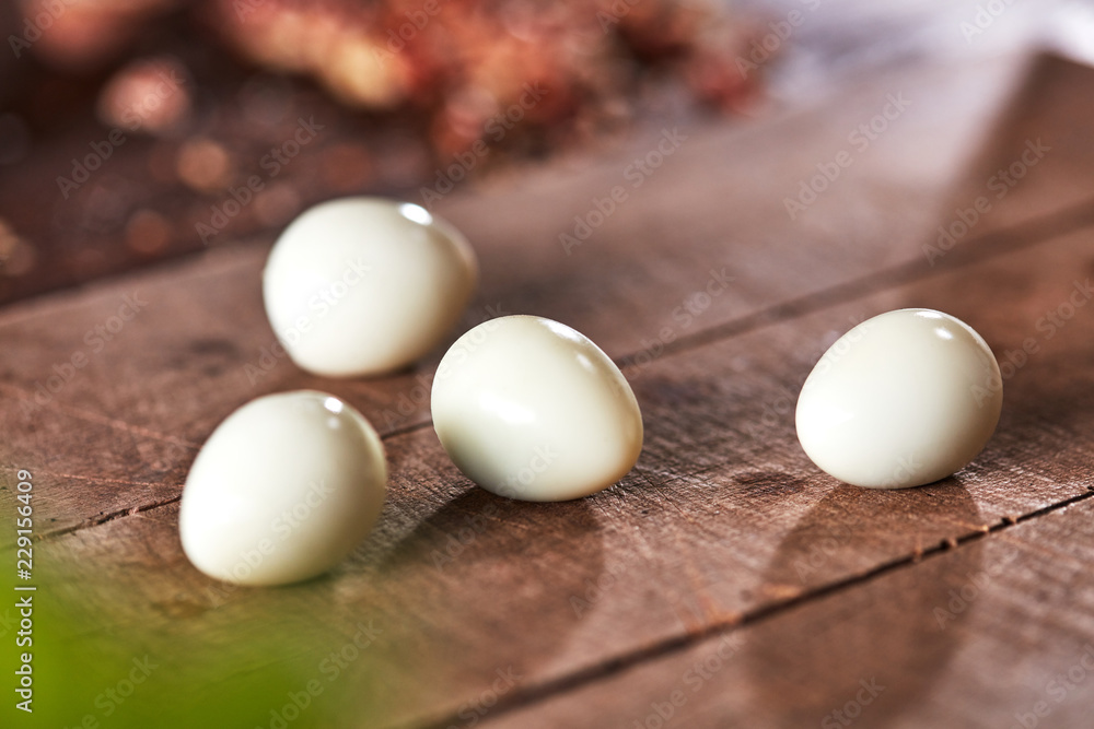 Cooking peeled quail eggs presented on an old wooden table. Ingredient for Healthy Salad. Cooking peeled quail eggs presented on an old wooden table. Ingredient for Healthy Salad.