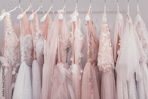 New design. Wedding dresses hanging together in the wedding boutique while waiting for someone to buy them