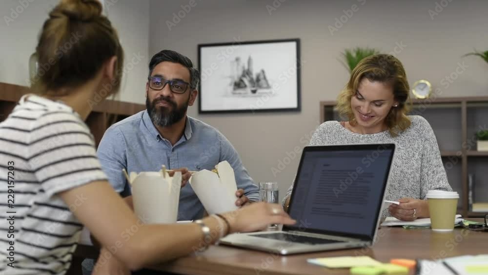 Businessman eating noodles with colleagues for lunch break Businessman eating noodles with colleagues for lunch break
