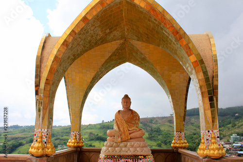 Smiling Buddha on one of the levels of Pha Sorn Kaew under a golden dome  at Pha Sorn Kaew  in Khao Kor  Phetchabun  Thailand.