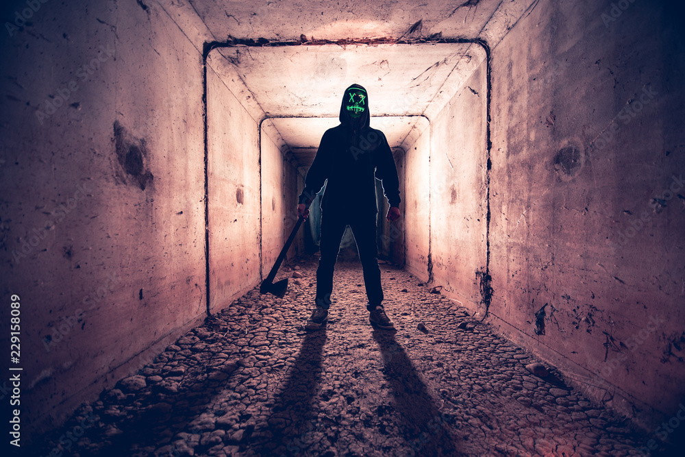 man with mask and ax on halloween
