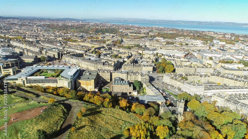 Aerial image looking across the north of the city of Edinburgh to the Firth of Forth on a bright autumn day.