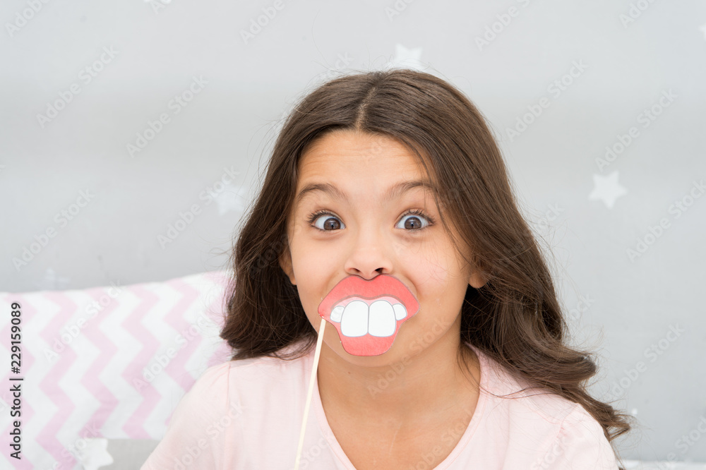 Just for fun. Happy little girl. Little girl hold fake mouth on face. Happy child and childhood. Every single childhood matters Just for fun. Happy little girl. Little girl hold fake mouth on face. Happy child and childhood. Every single childhood matters
