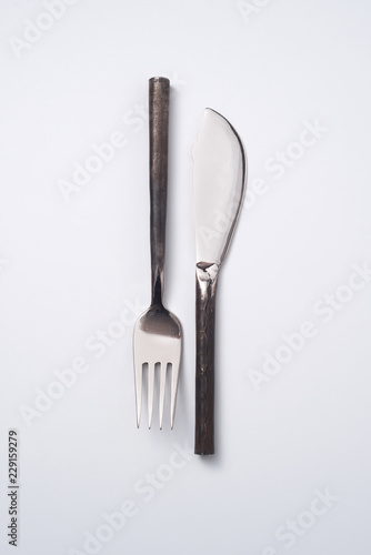 Metal vintage knife and fork isolated on gray background with copy space. Flat lay