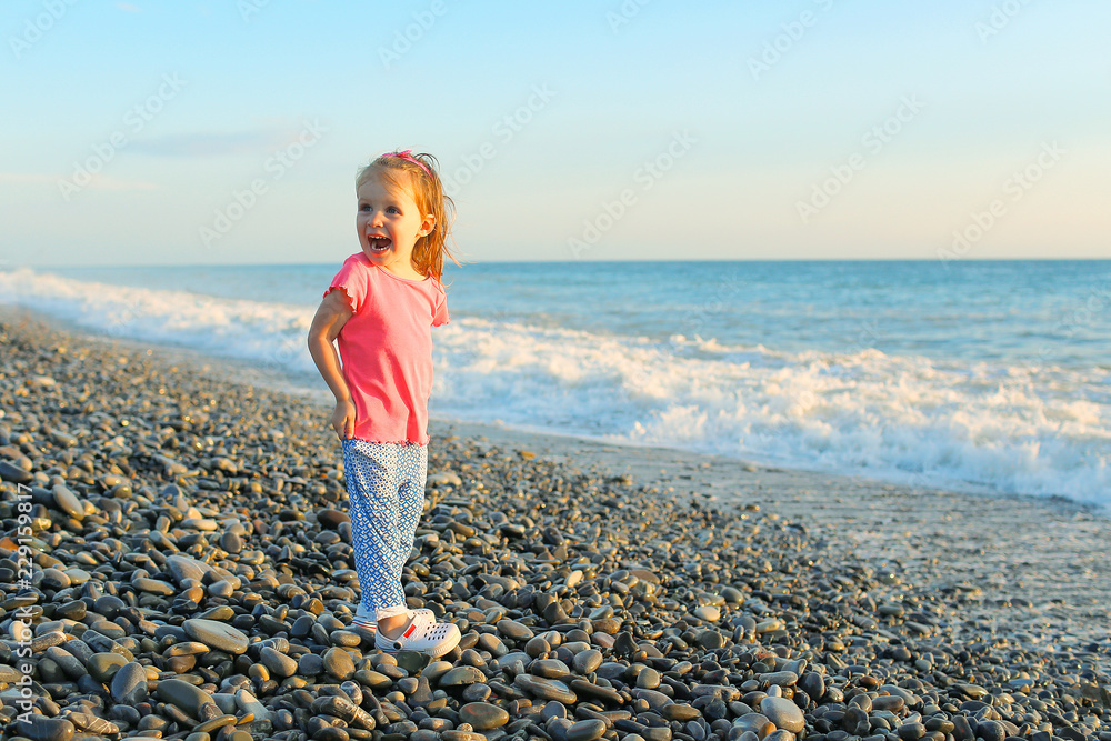 Cute happy smiling little girl on the seaside Stock Photo | Adobe Stock