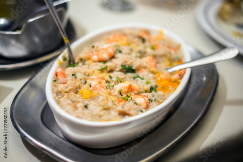 Traditional portuguese seafood dish with rice, shrimps and fresh egg yolk