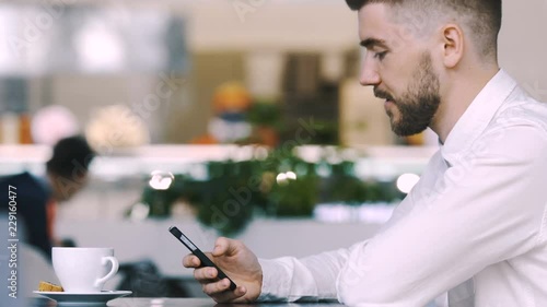 Handsome man in shirt sitting in cafe