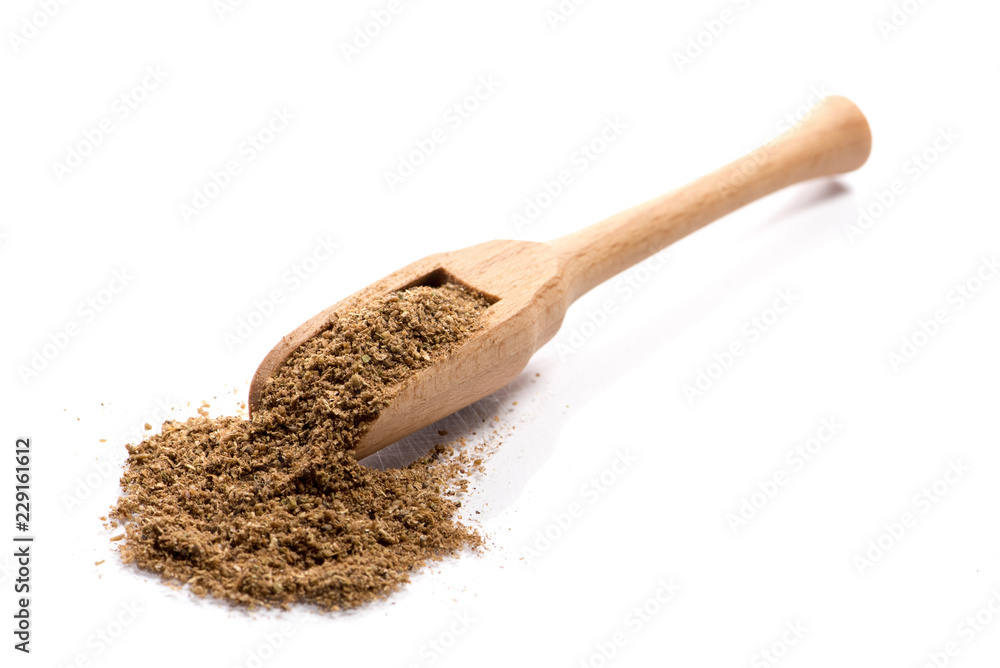 Φωτογραφία Close-up of pile of Garam Masala powder spice in a wooden spoon on white backgro