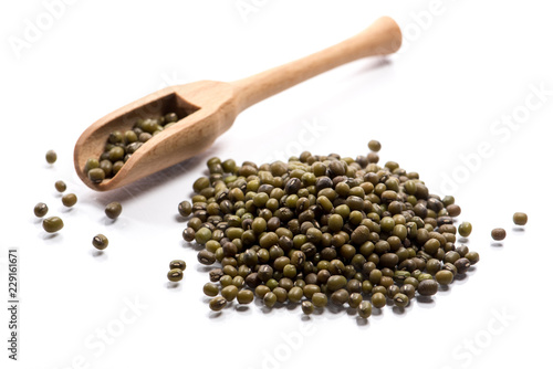 Close-up of pile of Mung beans in a wooden spoon on white background photo