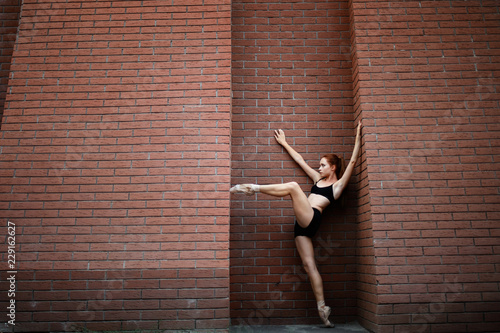 Elegant ballerina dancing ballet in the streets. Street ballet
