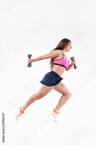 Fitness woman athlete and bodybuilder holding dumbbell on white background. Sport concept.