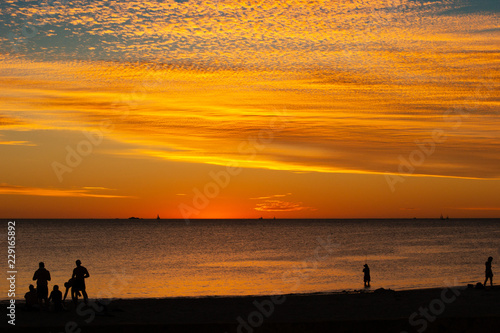 Landscape of silhouettes persons orange colors and contrast