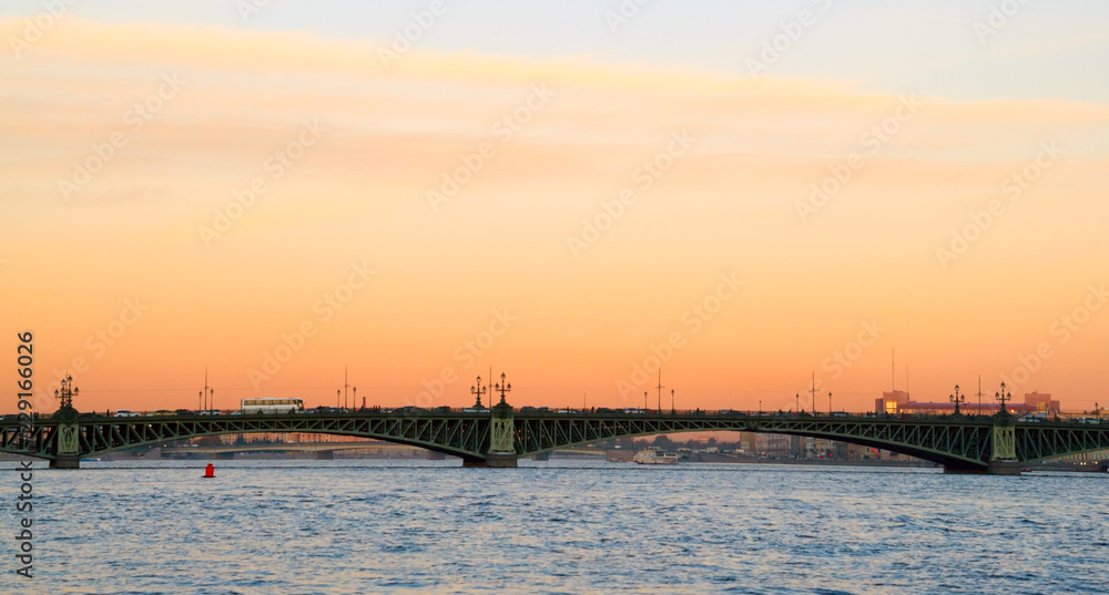 Troitsky bridge. Autumn city skyline at sunset, Neva river.