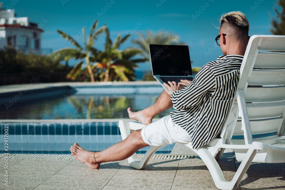 Guy with a laptop on vacation