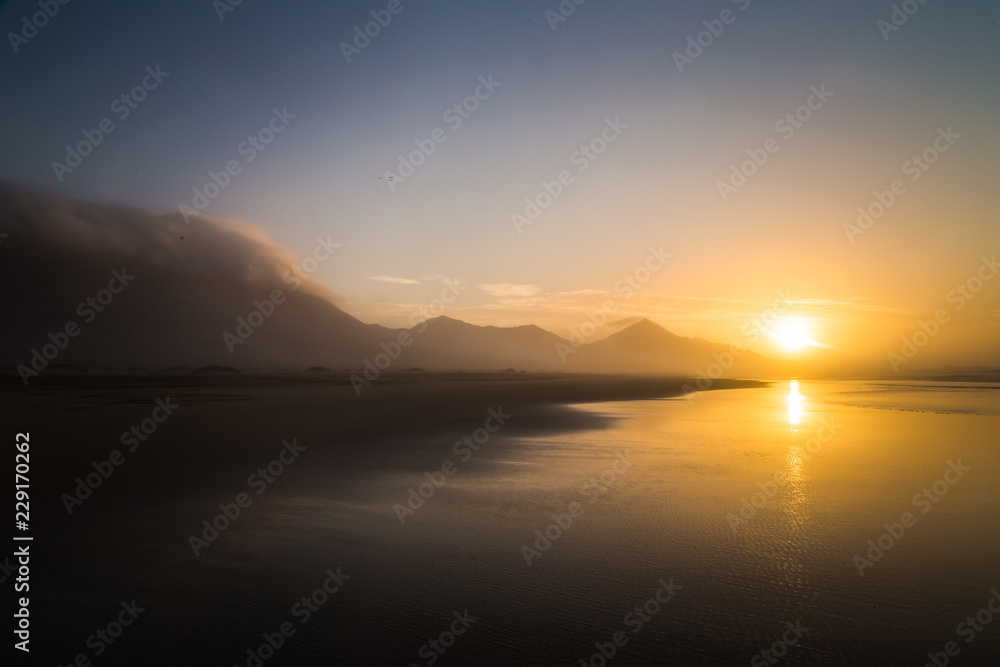 Lovely sundown silhouette of tropical Cofete beach in Fuerteventura, Canary Islands.