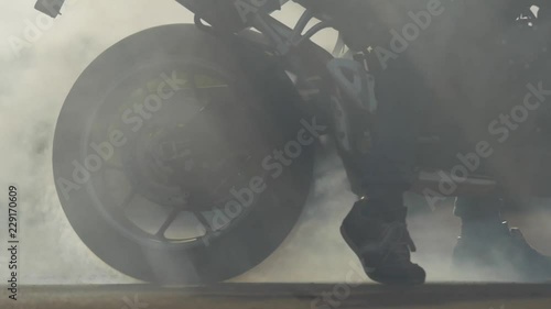 Motorbike burnout, Biker on a motorcycle drifts in smoke, burns tire on a motorcycle.