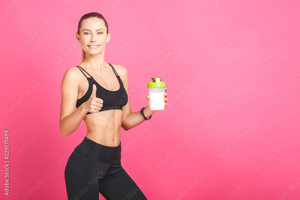 Nice sexy woman after workout with shaker isolated over white background. Fitness nutrition. Nice sexy woman after workout with shaker isolated over white background. Fitness nutrition.