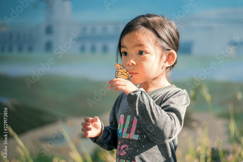 Young Girl Holding a Butterfly