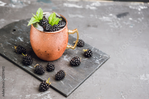 Canvas Print Blackberry moscow mule in copper mug on the rustic background