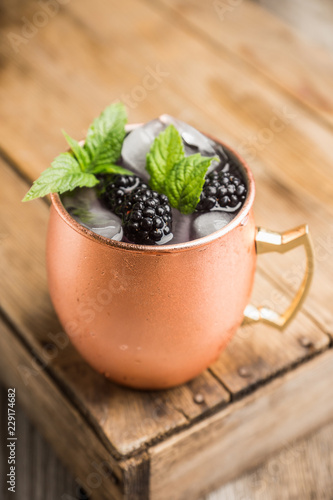 Canvas Print Blackberry moscow mule in copper mug on the rustic background