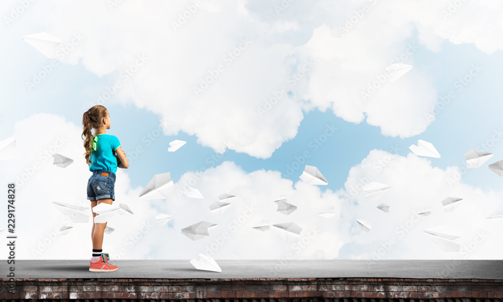 Concept of careless happy childhood with girl looking far away Concept of careless happy childhood with girl looking far away