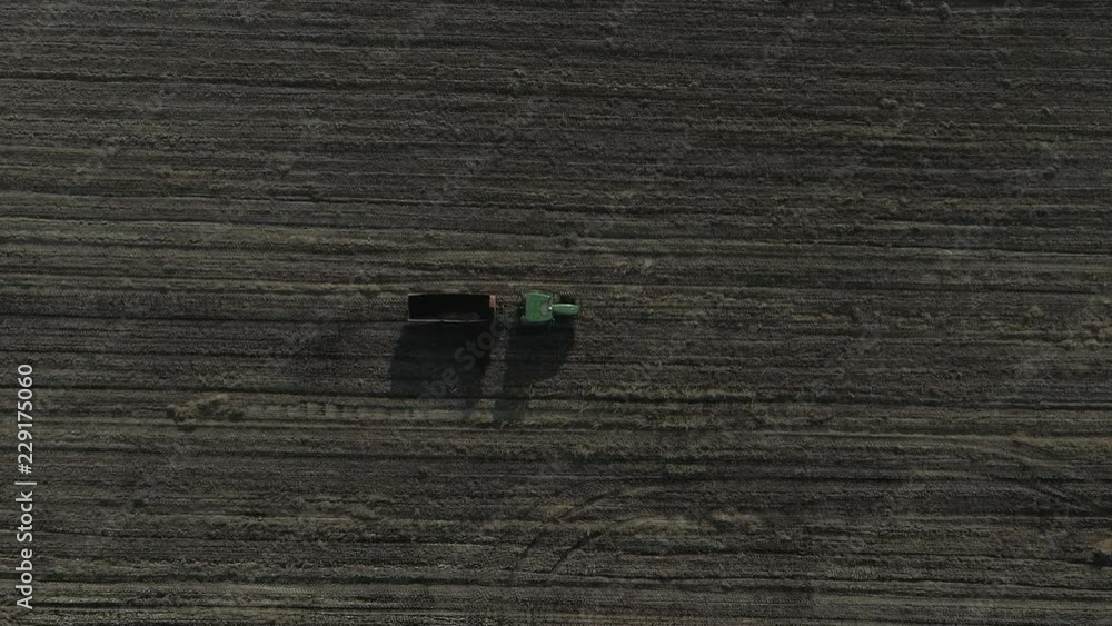 Aerial shot of Farmer with a tractor on the agricultural field sowing. tractors working on the agricultural field in Italy Aerial shot of Farmer with a tractor on the agricultural field sowing. tractors working on the agricultural field in Italy