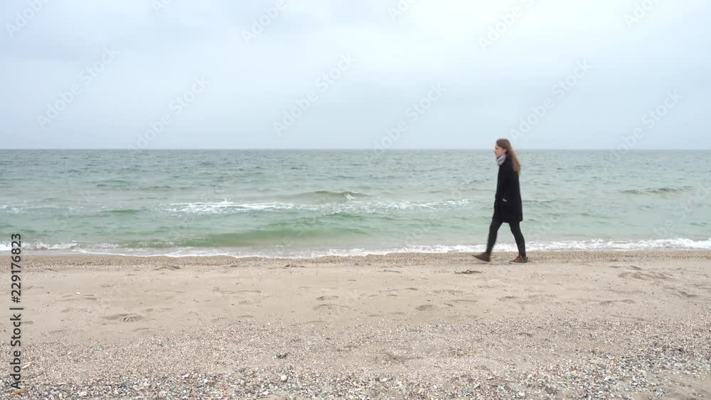 The girl walks on the beach. Shooting on the beach. The girl walks on the beach. Shooting on the beach.
