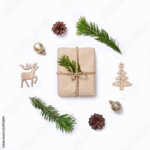 Christmas decorations, gift and fir tree branches on white background. Flat lay.