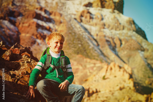 little boy enjoy hiking travel in mountains