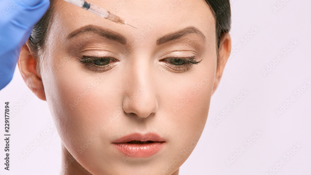 Fototapeta premium woman face injection. salon cosmetology procedure. skin medical care. dermatology treatment. anti aging wrinkle lifting