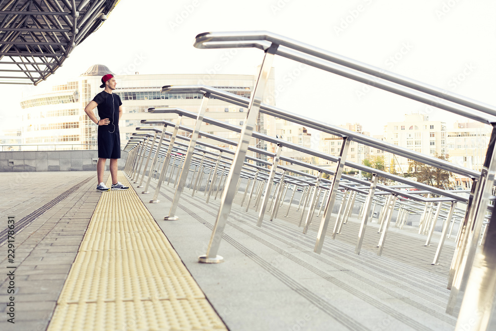 Urban man prepare to jogging in the city. Working out urban Urban man prepare to jogging in the city. Working out urban