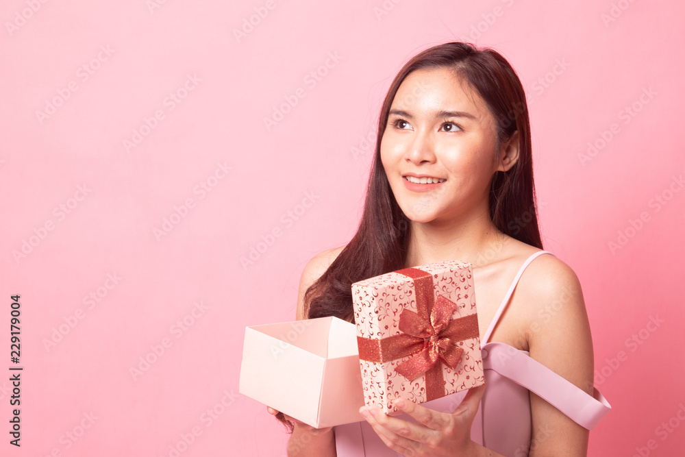 Young Asian woman with a gift box. Young Asian woman with a gift box.