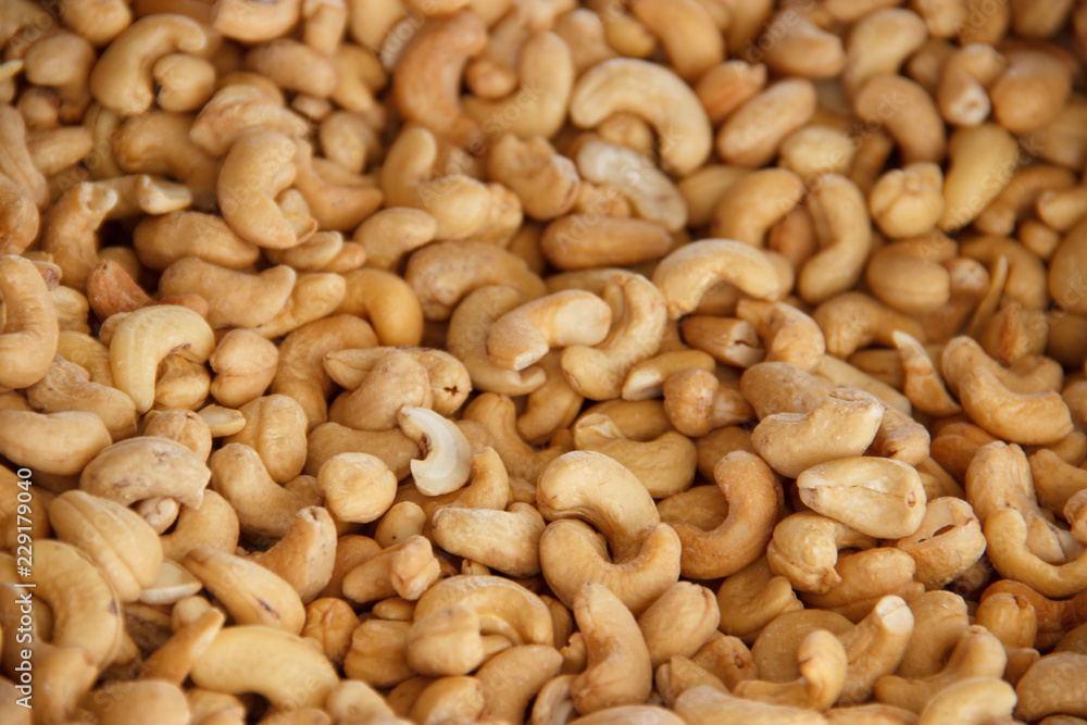 Cashews nut fried background. kernels of peeled nuts close up Cashews nut fried background. kernels of peeled nuts close up