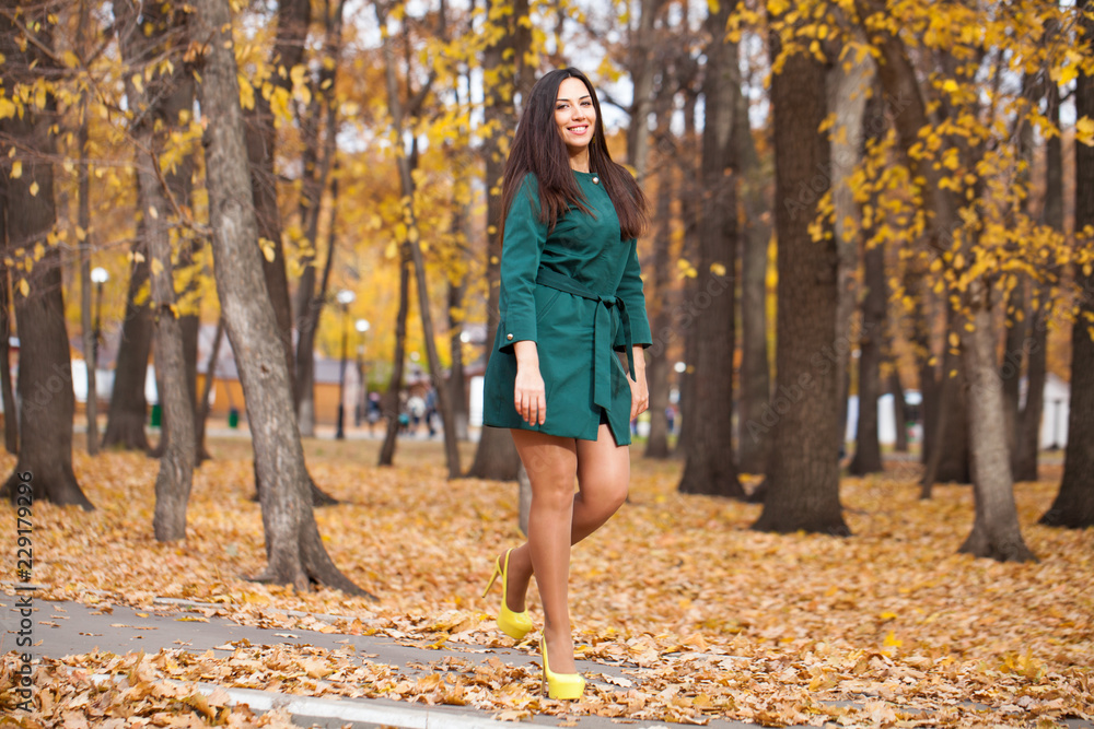 Portrait of a young beautiful brunette woman in short green coat Portrait of a young beautiful brunette woman in short green coat