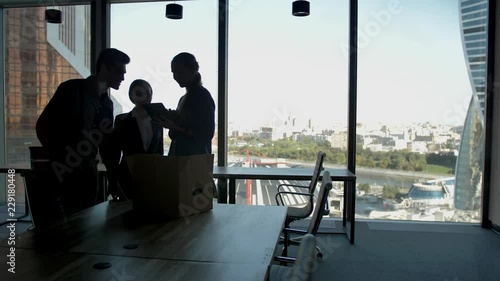 Several silhouettes of attractive handsome businesspeople interacting business center. Males and females contacting and cooperating with themselfs in glass modern business centre. Slow motion photo