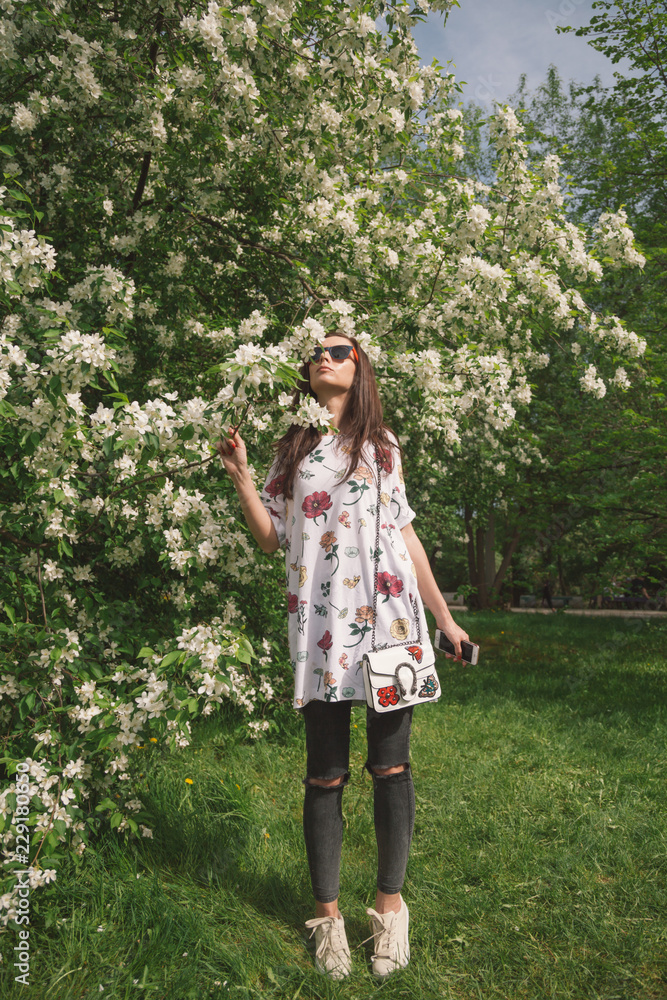 Attractive woman smells spring blossom tree