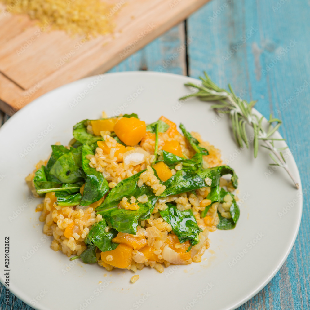 Bulgur with pumpkin and cutting board with ingredients Bulgur with pumpkin and cutting board with ingredients