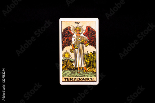 An individual major arcana tarot card isolated on black background. Temperance.