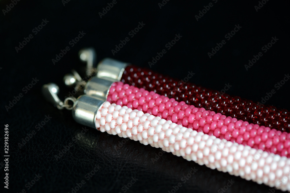 Set of three beaded bracelets on a dark background close up Set of three beaded bracelets on a dark background close up