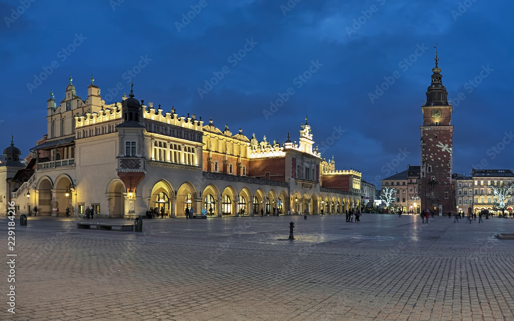 Krakow, Poland. Main Market Square (Rynek Glowny) with Cloth Hall (Sukiennice) and free-standing Town Hall Tower in Christmas illumination.