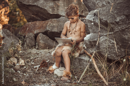 Fotografie Caveman, manly boy using tablet PC