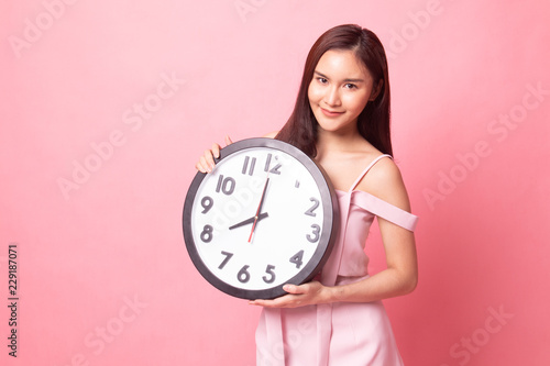 Young Asian woman with a clock