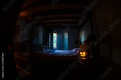 Halloween pumpkin head jack lantern in dark bedroom